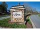 Elegant stone sign for Legacy at Jordan Lake community, surrounded by lush landscaping at 272 High Woods Rdg, Chapel Hill, NC 27517