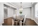 Dining room features a stylish table, chairs and lighting adjacent to the stairway at 272 High Woods Rdg, Chapel Hill, NC 27517