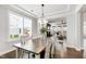 Elegant dining room with a large table, decorative lighting, and bright windows at 272 High Woods Rdg, Chapel Hill, NC 27517