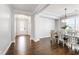 Elegant dining room with dark wood floors, a modern chandelier, and natural light at 272 High Woods Rdg, Chapel Hill, NC 27517