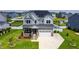 Beautiful two-story home with solar panels, manicured lawn, and a welcoming stone porch at 272 High Woods Rdg, Chapel Hill, NC 27517