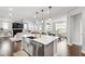 Spacious kitchen with an island, stainless steel sink, and open view to the living area at 272 High Woods Rdg, Chapel Hill, NC 27517