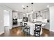 Modern kitchen featuring gray cabinets, a center island with bar stools, and stainless appliances at 272 High Woods Rdg, Chapel Hill, NC 27517