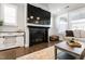 Inviting living room with a cozy fireplace, mounted TV, and plantation shutters for natural light at 272 High Woods Rdg, Chapel Hill, NC 27517