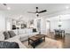Open-concept living room with modern furniture, ceiling fan, and seamless flow to dining area at 272 High Woods Rdg, Chapel Hill, NC 27517