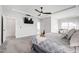Spacious main bedroom features a tray ceiling, a ceiling fan, a large bed, and an en-suite bathroom at 272 High Woods Rdg, Chapel Hill, NC 27517