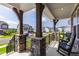 Inviting front porch with stone pillars and rocking chairs, perfect for enjoying the outdoors at 272 High Woods Rdg, Chapel Hill, NC 27517