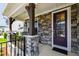 Close-up of a charming porch with stone accents and a decorative front door at 272 High Woods Rdg, Chapel Hill, NC 27517
