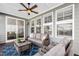 Relaxing outdoor porch area, furnished with a sofa, chairs, and a coffee table at 272 High Woods Rdg, Chapel Hill, NC 27517