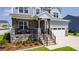 Charming front porch with stone accents, wrought iron railings, and comfortable seating at 272 High Woods Rdg, Chapel Hill, NC 27517