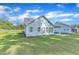 Spacious backyard with lush green lawn and a view of the home's light blue siding and covered patio at 30 Sawtooth Oak Ln, Youngsville, NC 27596