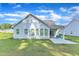 The home features a large backyard with healthy, green grass and a covered back patio at 30 Sawtooth Oak Ln, Youngsville, NC 27596