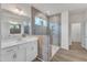 Bathroom features a modern glass enclosed shower, double vanity and neutral tile work at 30 Sawtooth Oak Ln, Youngsville, NC 27596