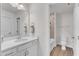 Bright bathroom with a wide mirror, quartz counters, and a toilet in the tiled shower room at 30 Sawtooth Oak Ln, Youngsville, NC 27596