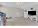 Bedroom with carpeted floors, tv and large windows at 30 Sawtooth Oak Ln, Youngsville, NC 27596