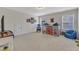 Spacious bedroom with carpeted floors, a TV and large windows at 30 Sawtooth Oak Ln, Youngsville, NC 27596