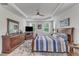 A spacious bedroom boasts tray ceilings, many windows, and hardwood flooring at 30 Sawtooth Oak Ln, Youngsville, NC 27596