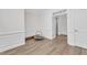 Bright bonus room showcasing wainscoting, wood floors, and an open doorway at 30 Sawtooth Oak Ln, Youngsville, NC 27596