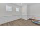 Spacious bonus room featuring wood floors, wainscoting, and plenty of natural light at 30 Sawtooth Oak Ln, Youngsville, NC 27596