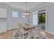 Charming dining room with wood table, seating for six, and sliding glass door to backyard at 30 Sawtooth Oak Ln, Youngsville, NC 27596