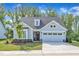 Charming home featuring a two-car garage, well-manicured lawn and lovely curb appeal at 30 Sawtooth Oak Ln, Youngsville, NC 27596