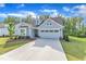 Inviting home featuring an attached two-car garage and a long concrete driveway at 30 Sawtooth Oak Ln, Youngsville, NC 27596