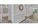 Elegant hallway with decorative mirror, access to bath, and view to living space at 30 Sawtooth Oak Ln, Youngsville, NC 27596