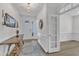 Spacious hallway featuring hardwood floors, elegant decor, and natural light at 30 Sawtooth Oak Ln, Youngsville, NC 27596