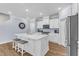 Open kitchen with stainless steel appliances, white cabinets, and a quartz countertop island at 30 Sawtooth Oak Ln, Youngsville, NC 27596