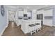 Well-lit kitchen with quartz countertop island and stainless steel appliances at 30 Sawtooth Oak Ln, Youngsville, NC 27596