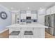 Elegant kitchen with large island, stainless appliances, and stylish design features at 30 Sawtooth Oak Ln, Youngsville, NC 27596