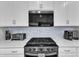 Modern kitchen featuring stainless steel appliances, sleek countertops, and white cabinets at 30 Sawtooth Oak Ln, Youngsville, NC 27596