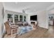 Cozy living room featuring a fireplace, large windows, and comfortable seating at 30 Sawtooth Oak Ln, Youngsville, NC 27596