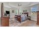 Serene main bedroom with a tray ceiling, large windows, and dark wood furniture at 30 Sawtooth Oak Ln, Youngsville, NC 27596