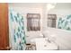 Bright bathroom with white tile, a patterned shower curtain, and a classic sink at 3301 Amherst Rd, Rocky Mount, NC 27804