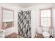 Bathroom featuring a walk-in shower with a gray floral shower curtain, a toilet, and a window at 3301 Amherst Rd, Rocky Mount, NC 27804