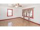 Bright bedroom featuring wood floors, and a window with decorative curtains at 3301 Amherst Rd, Rocky Mount, NC 27804