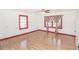 Bright, empty bedroom with hardwood floors and two windows offering plenty of natural light at 3301 Amherst Rd, Rocky Mount, NC 27804