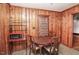 Dining area featuring wood-paneled walls, laminate floors, and a vintage microwave and hutch at 3301 Amherst Rd, Rocky Mount, NC 27804