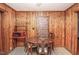 Cozy dining area featuring wood paneling, a dining table with chairs, and a microwave at 3301 Amherst Rd, Rocky Mount, NC 27804