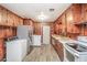 Kitchen featuring wood-paneled walls and cabinets, laminate floor, and a stainless steel refrigerator at 3301 Amherst Rd, Rocky Mount, NC 27804