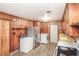 Functional kitchen space with wood paneling, appliances, and a utility area with washer and dryer at 3301 Amherst Rd, Rocky Mount, NC 27804