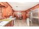 Charming kitchen with wood paneled walls, appliances, and dining area at 3301 Amherst Rd, Rocky Mount, NC 27804