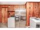Laundry room with washer, dryer, and stainless steel refrigerator and wood-paneled walls at 3301 Amherst Rd, Rocky Mount, NC 27804
