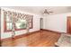 Cozy living room featuring hardwood floors, a ceiling fan, and a bright window with decorative curtains at 3301 Amherst Rd, Rocky Mount, NC 27804