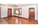 Inviting living room with hardwood floors, a ceiling fan, and a bright window with decorative curtains at 3301 Amherst Rd, Rocky Mount, NC 27804