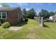 Fenced yard features lush green grass and mature trees, providing privacy and a serene outdoor space at 3301 Amherst Rd, Rocky Mount, NC 27804