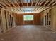 Unfinished bedroom reveals framing with one window for natural light at 332 Inspiration Way, Fuquay Varina, NC 27526