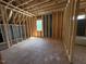 Unfinished bedroom displays exposed framing, window, and potential layout at 332 Inspiration Way, Fuquay Varina, NC 27526
