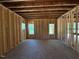 Unfinished room showing framing and a window view to the outside at 332 Inspiration Way, Fuquay Varina, NC 27526